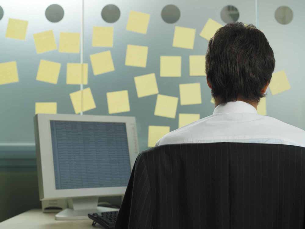 Man with adhesive notes in his office